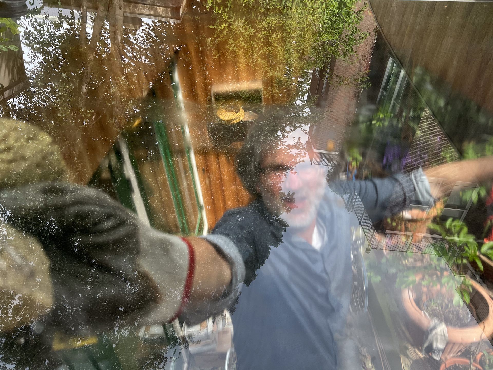 Older man handles and cleans a window from inside the house. Older man handles and cleans a window from inside the house.