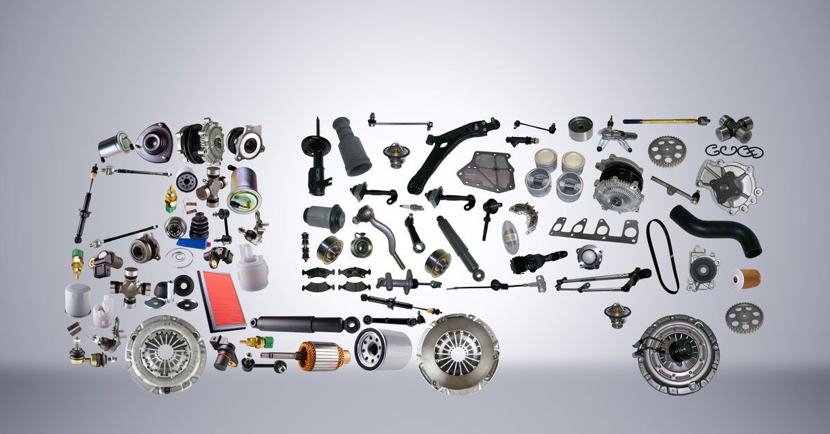 A wide spread of auto parts, including filters, shocks, gears, and brake components, arranged into the shape of a semitrailer.