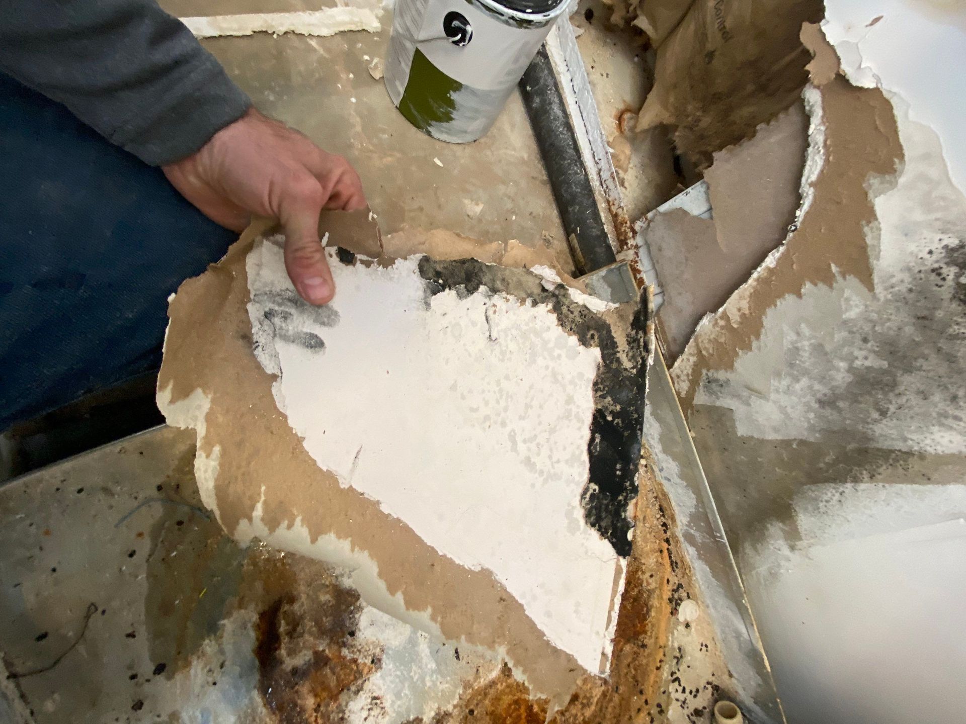 A person is peeling off a piece of paper with a spatula