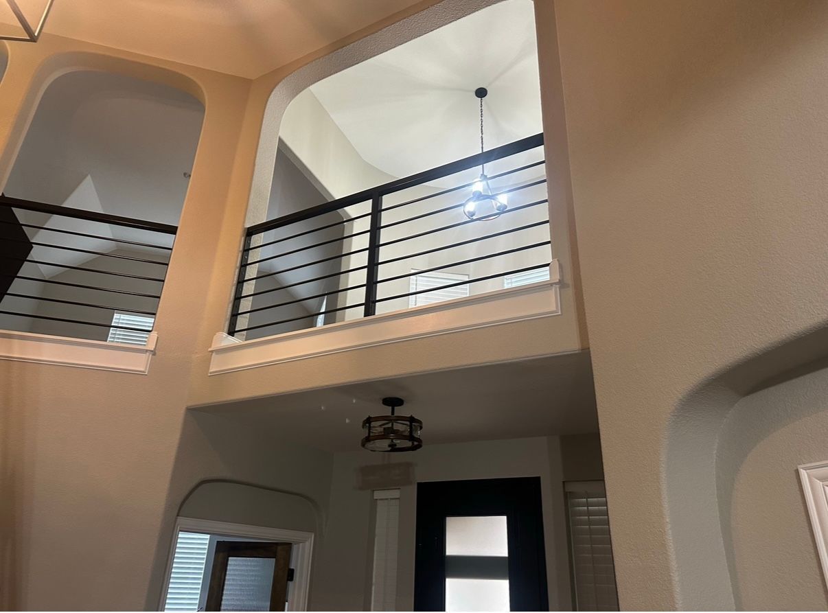 A house with a balcony and a ceiling fan