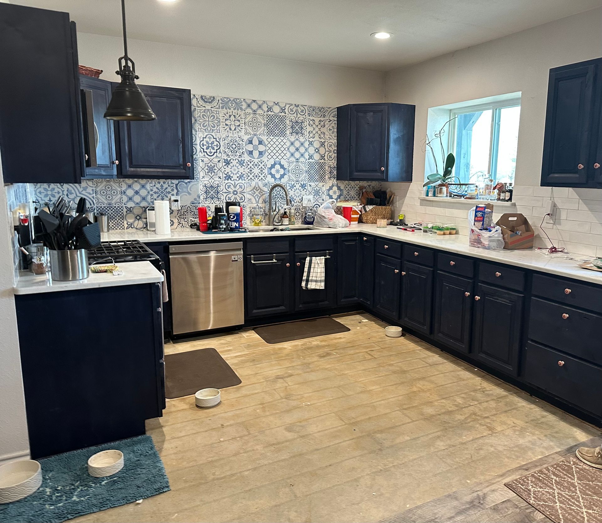 A kitchen with black cabinets and stainless steel appliances