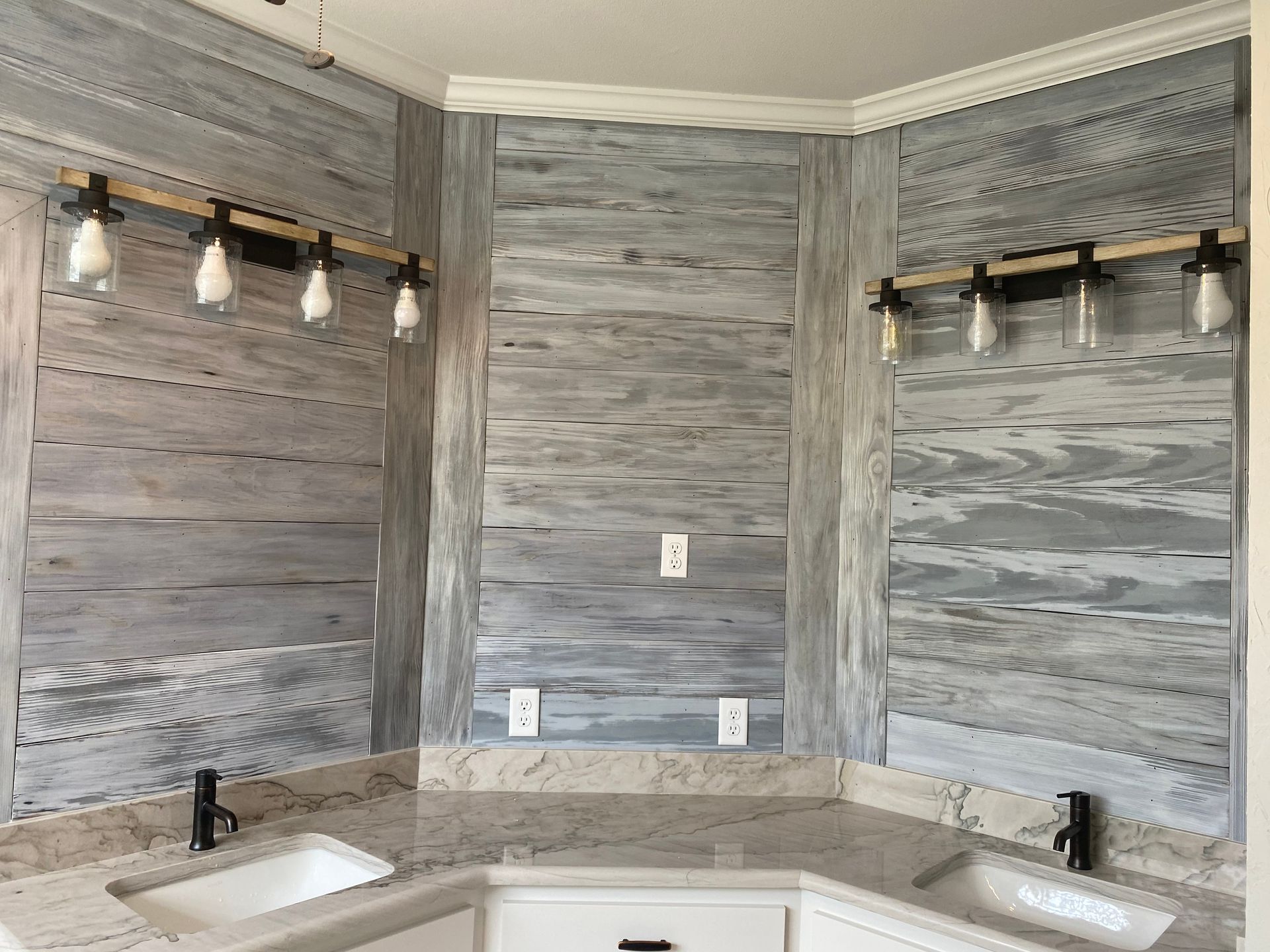 A bathroom with two sinks and a wooden wall.