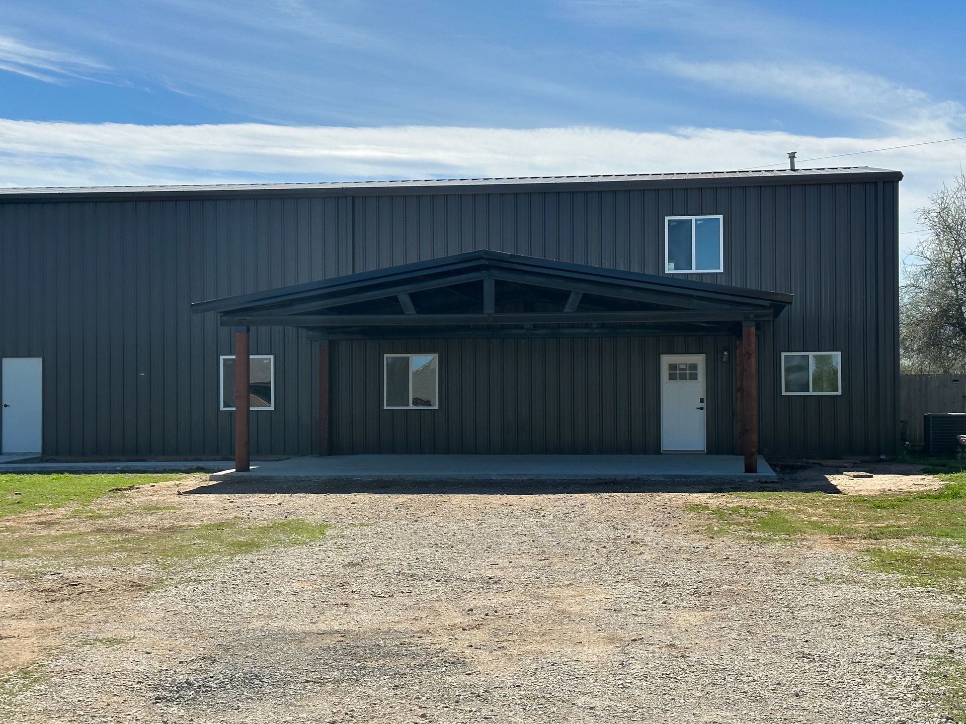 A large building with a covered porch and a lot of windows