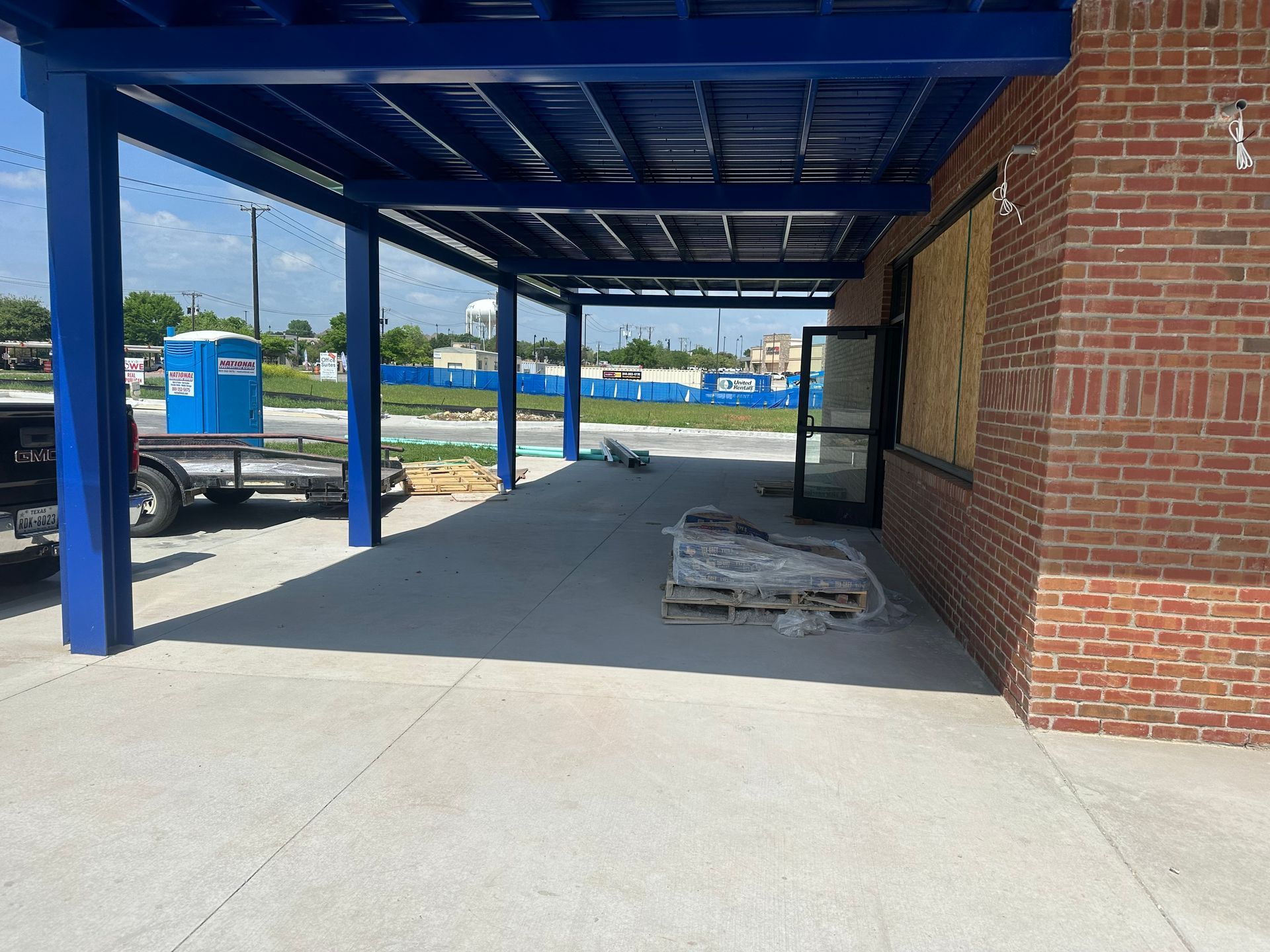 A brick building with a blue awning over it