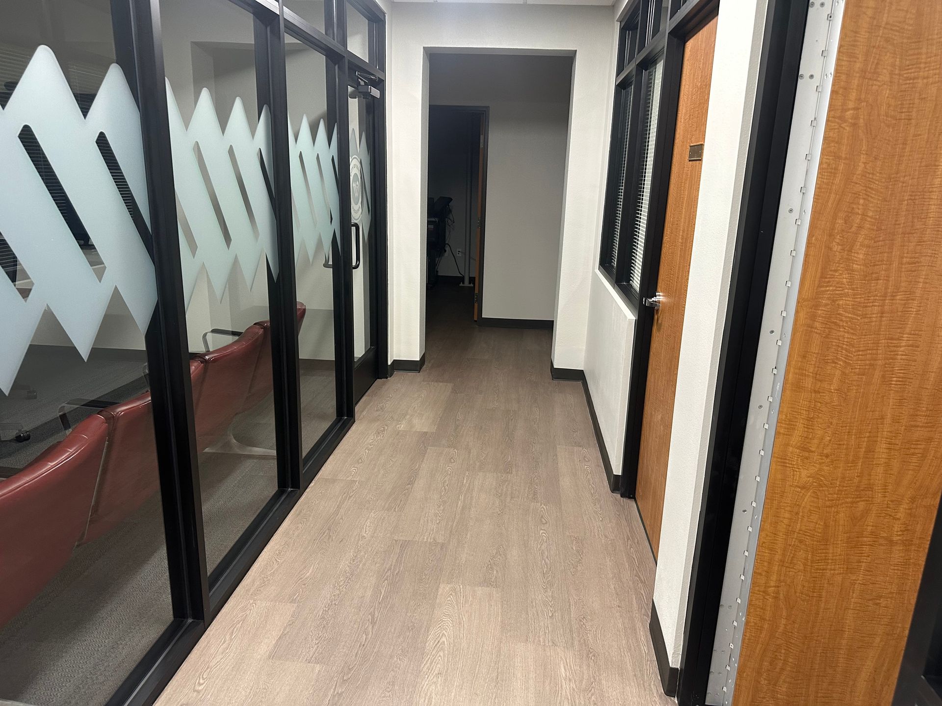 A long hallway with a lot of windows and doors