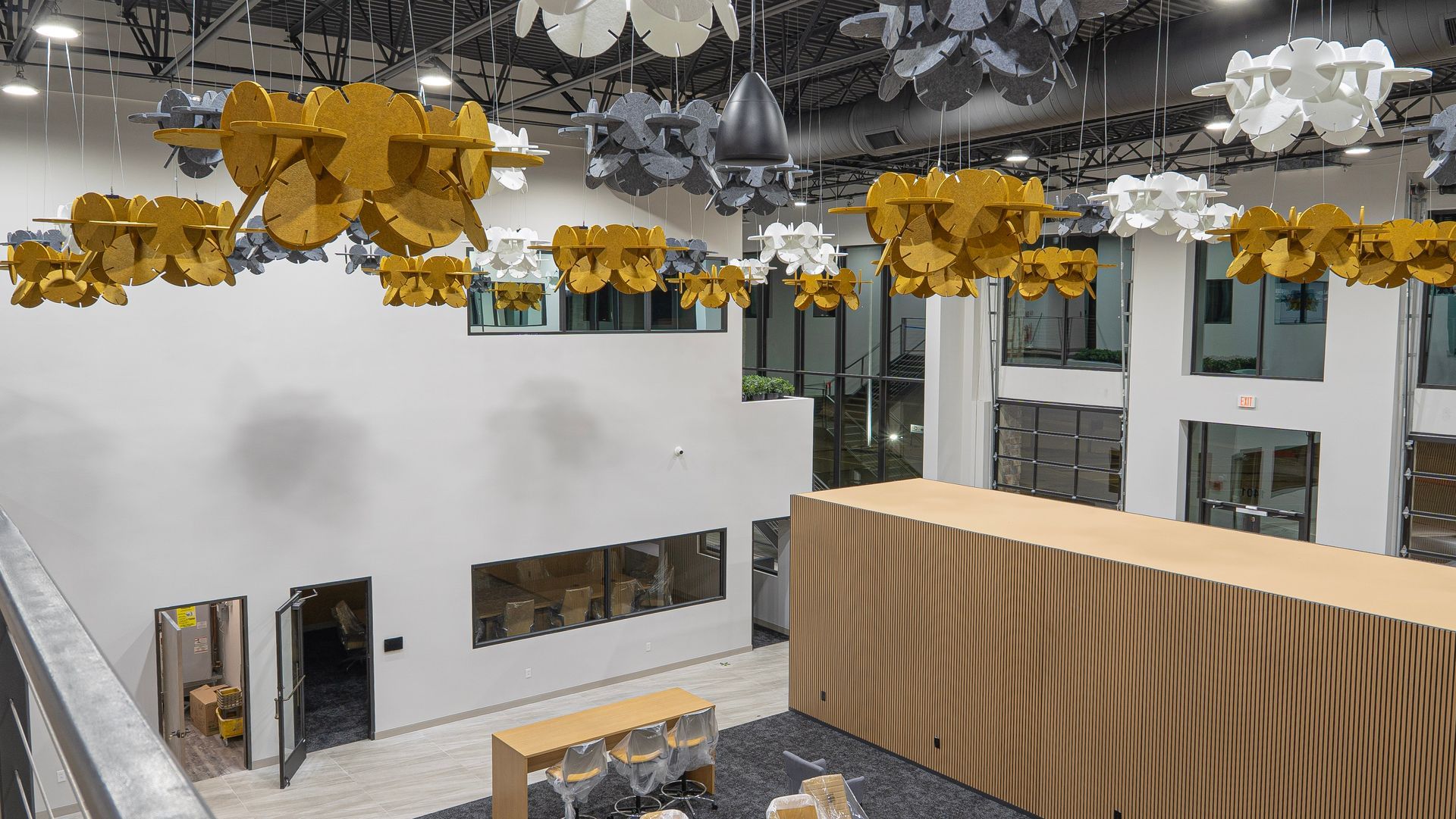 An aerial view of a large room with a wooden table and chairs.