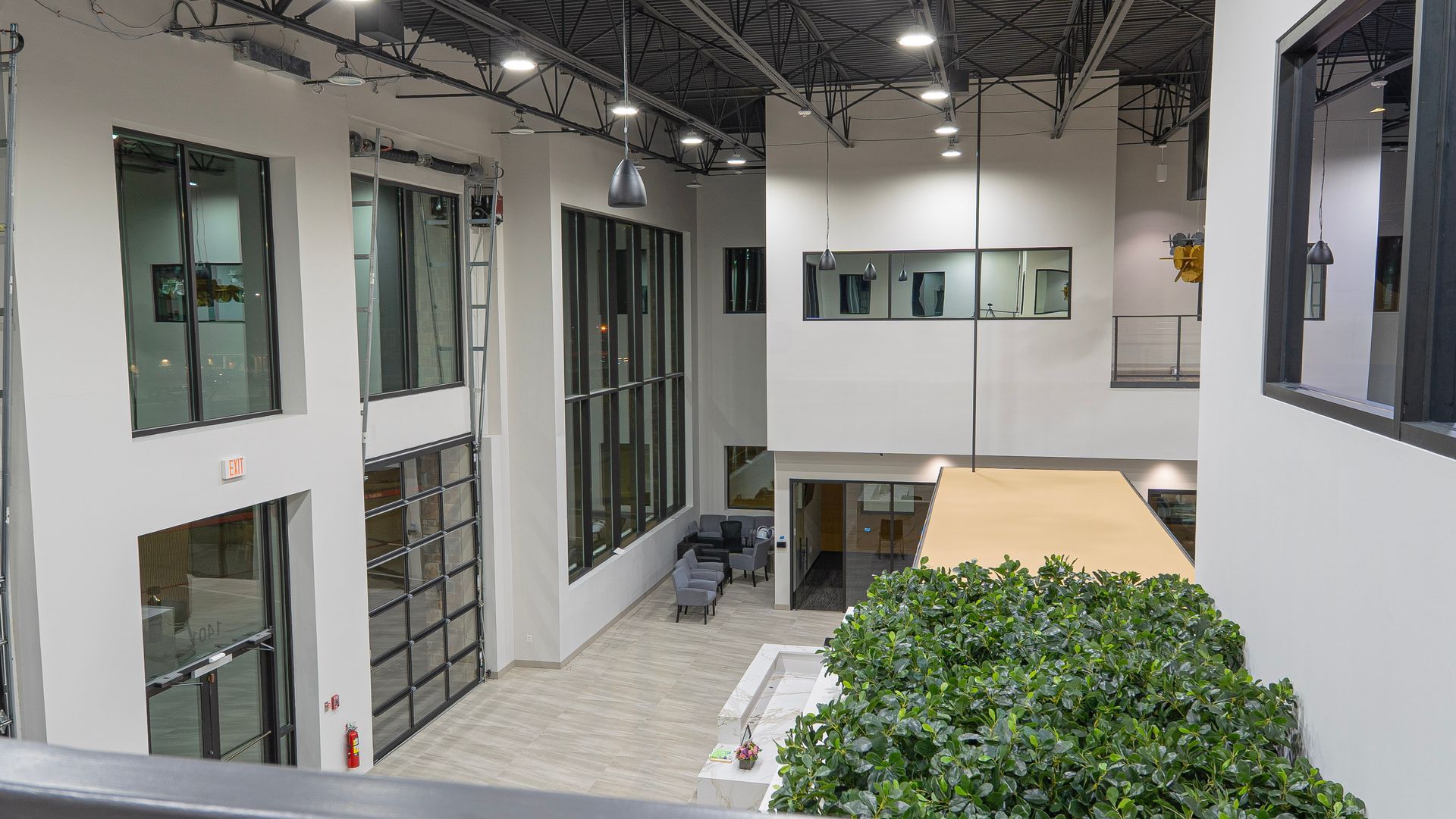 A large building with a lot of windows and a tree in the middle of it.