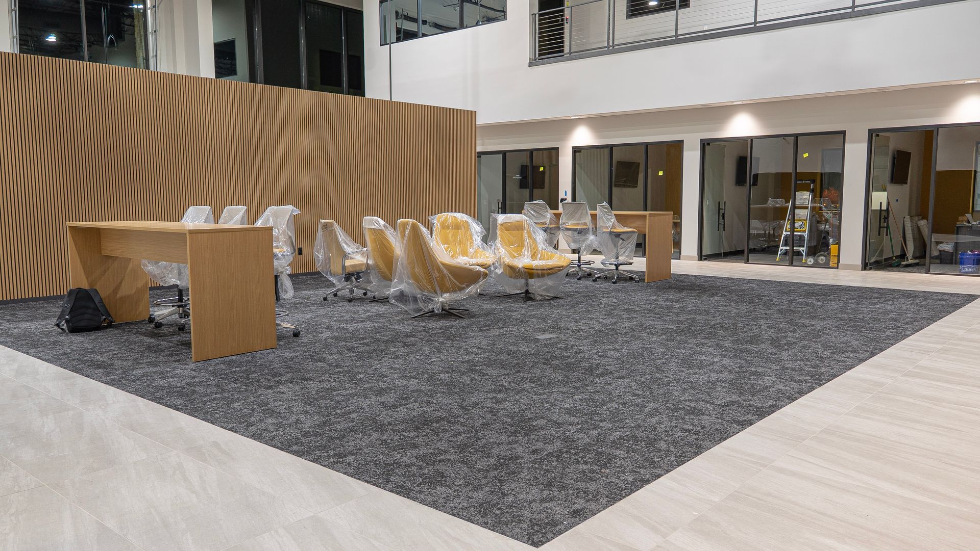 A large room with a lot of chairs and tables in it.