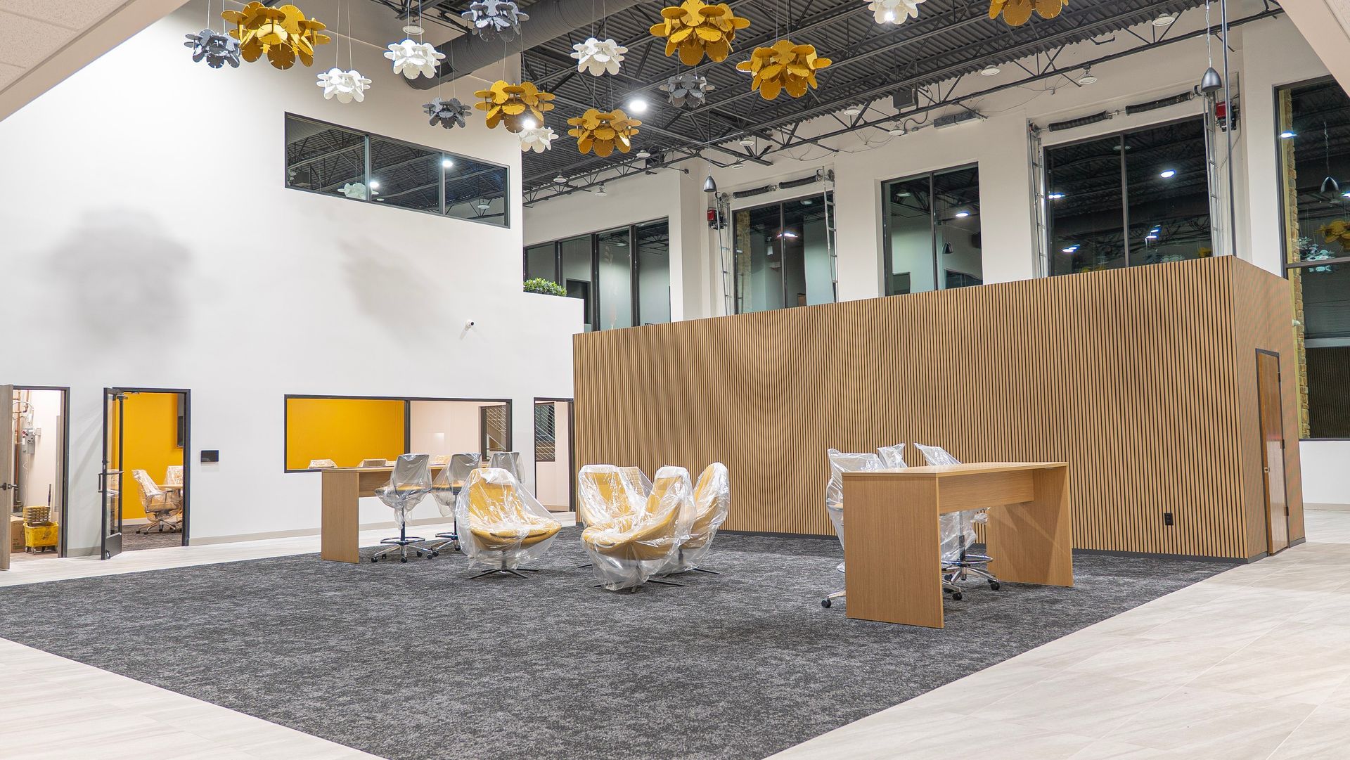 A large room with a table and chairs in it.