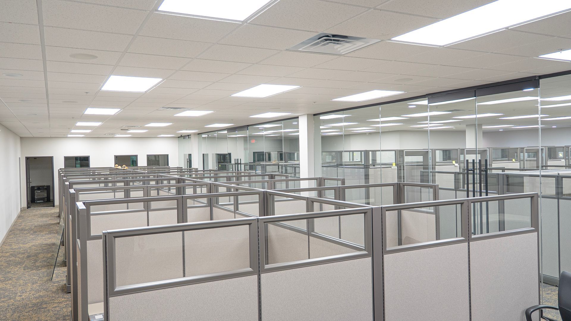 A large office with cubicles and glass walls