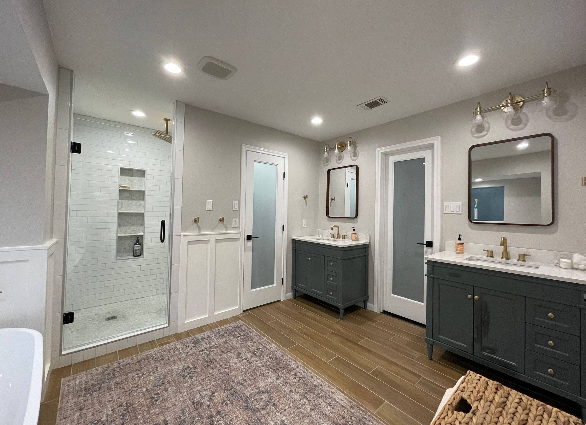 A kitchen with white cabinets and a large island