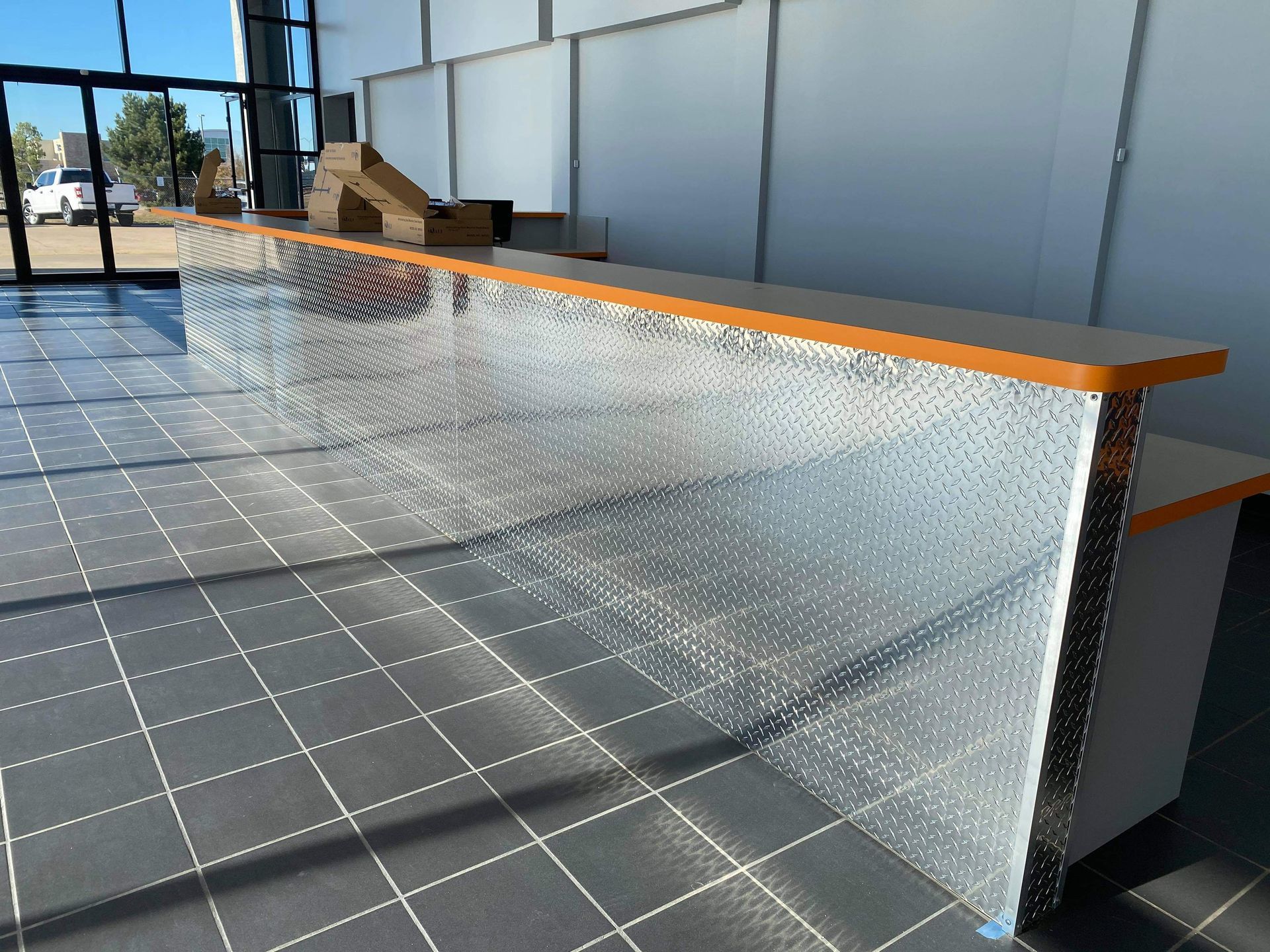 A reception desk in a building with a tiled floor