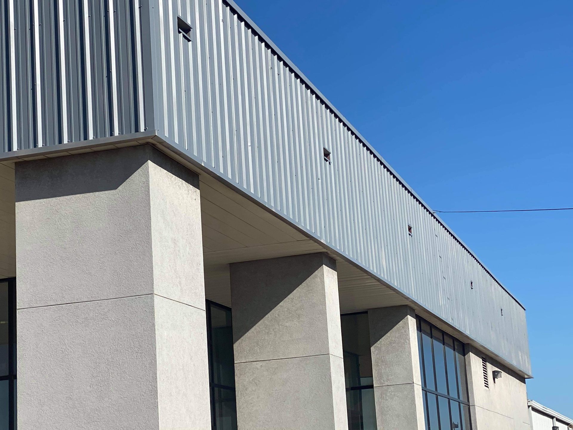 A large building with columns and a blue sky in the background