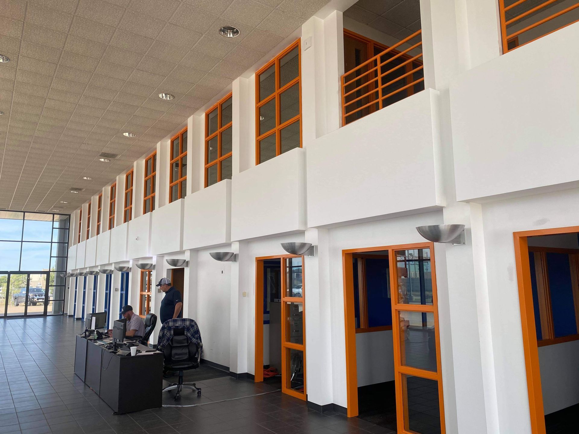 A large room with a lot of windows and doors