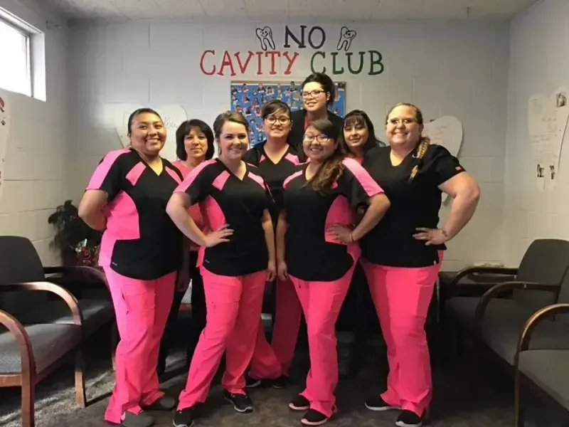 Group of women in pink scrubs posing by