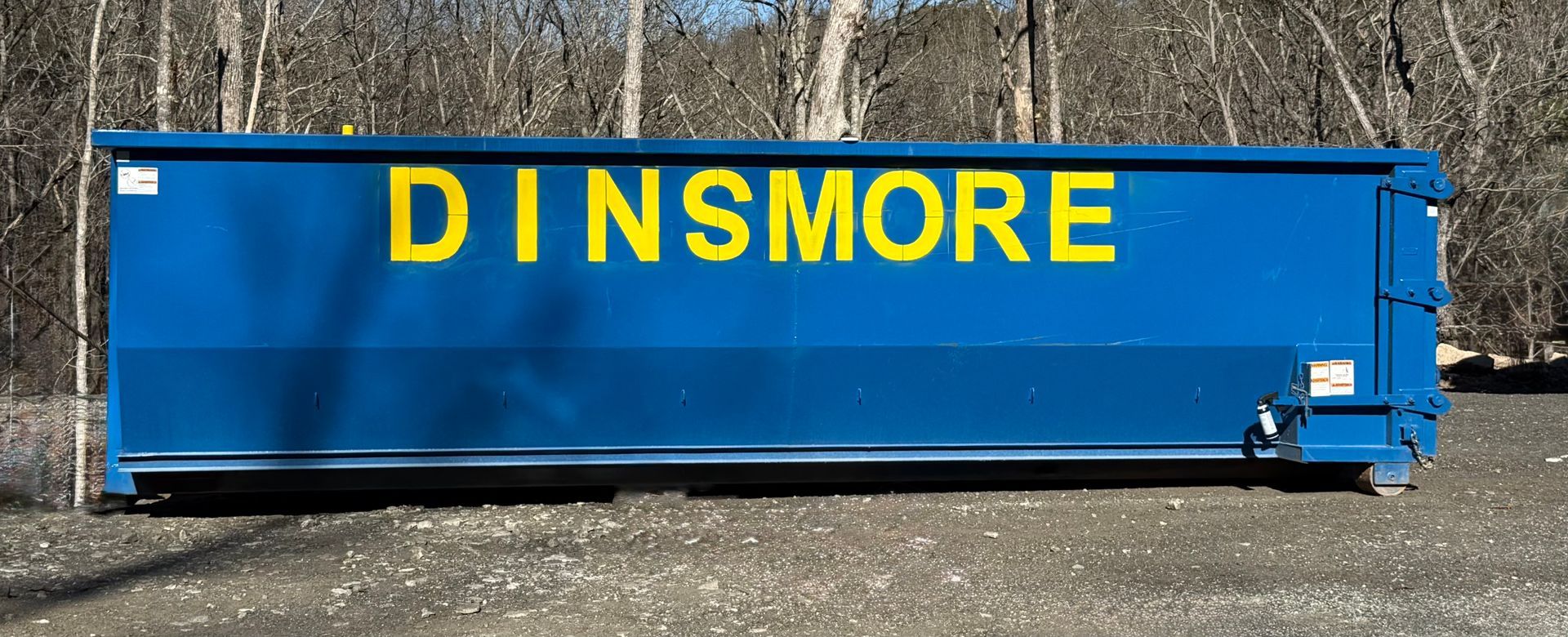 Blue dumpster with yellow 