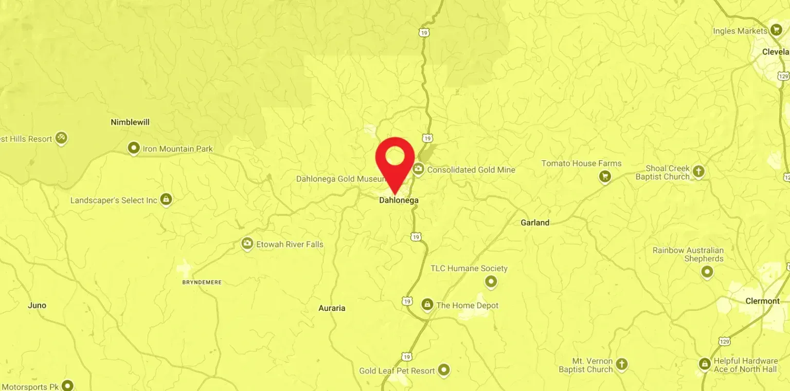 Map with a red location marker, likely indicating a city. Light yellow background.