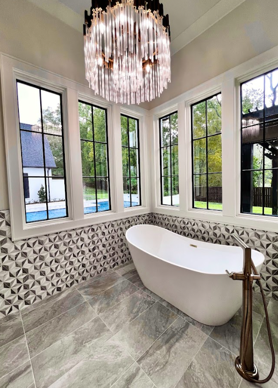 A modern walk-in shower with a glass enclosure, white and blue tile, and a built-in bench.