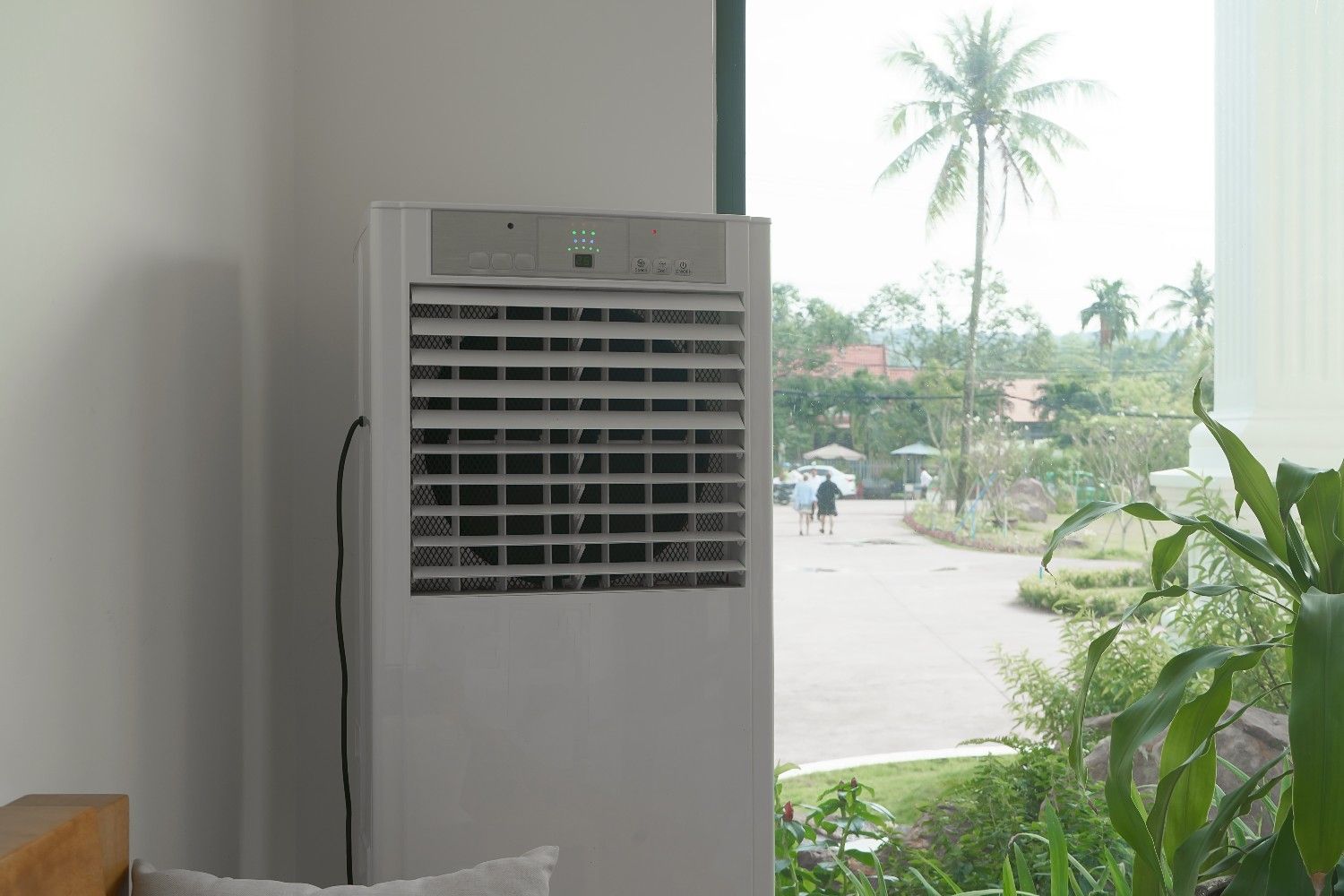 White Air Cooler Next to Window — Messina Air Conditioning & Electrical in Gordonvale, QLD