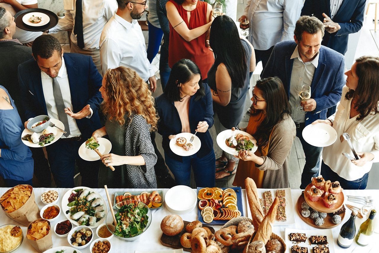 A group of people are sitting around a table eating food.