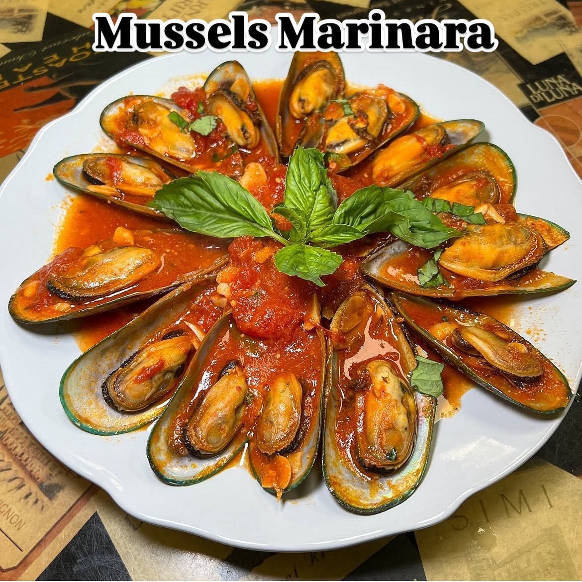 A white bowl filled with broccoli and shrimp on a table.