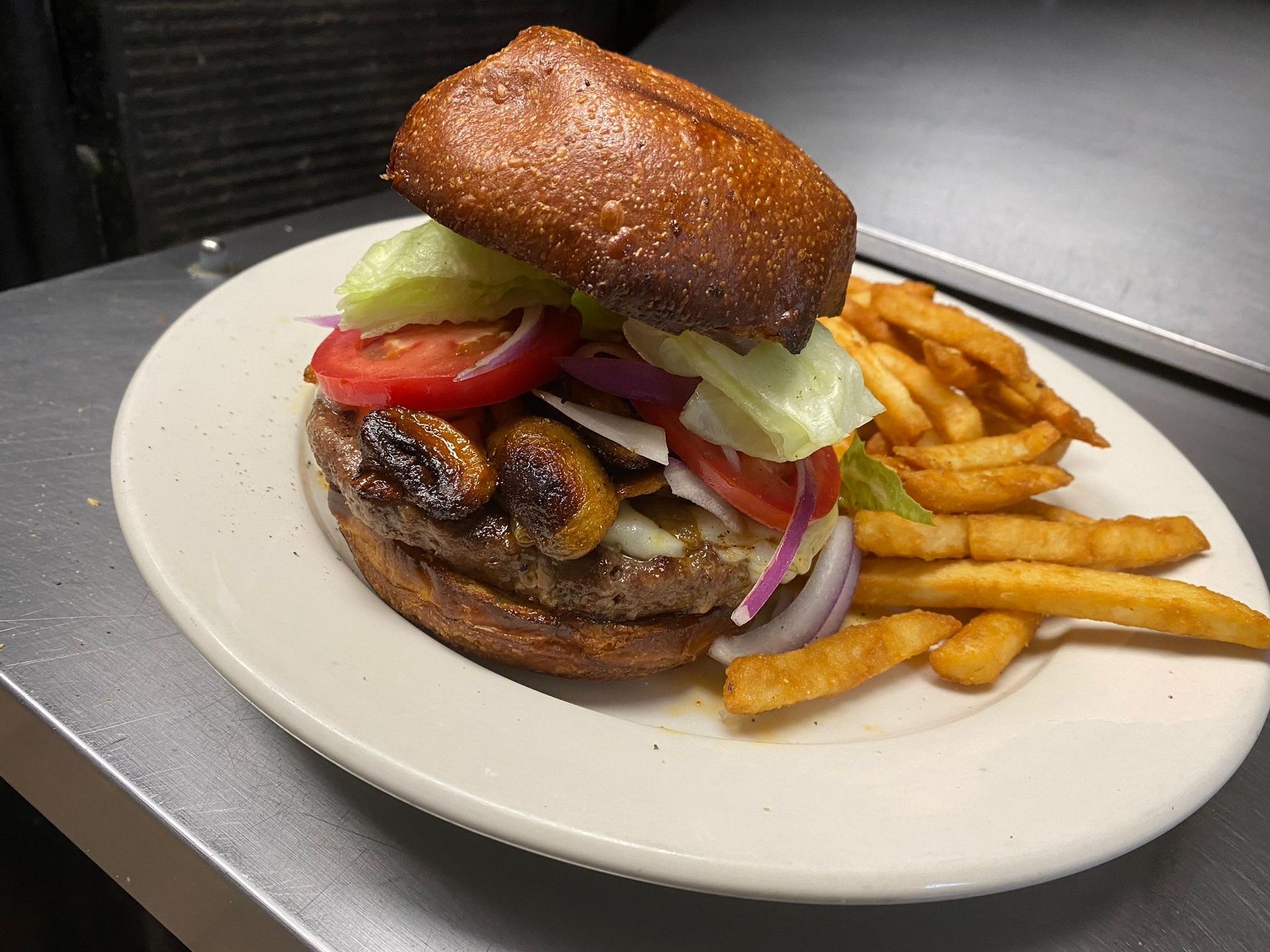 A basket of fried fish and french fries on a checkered paper.