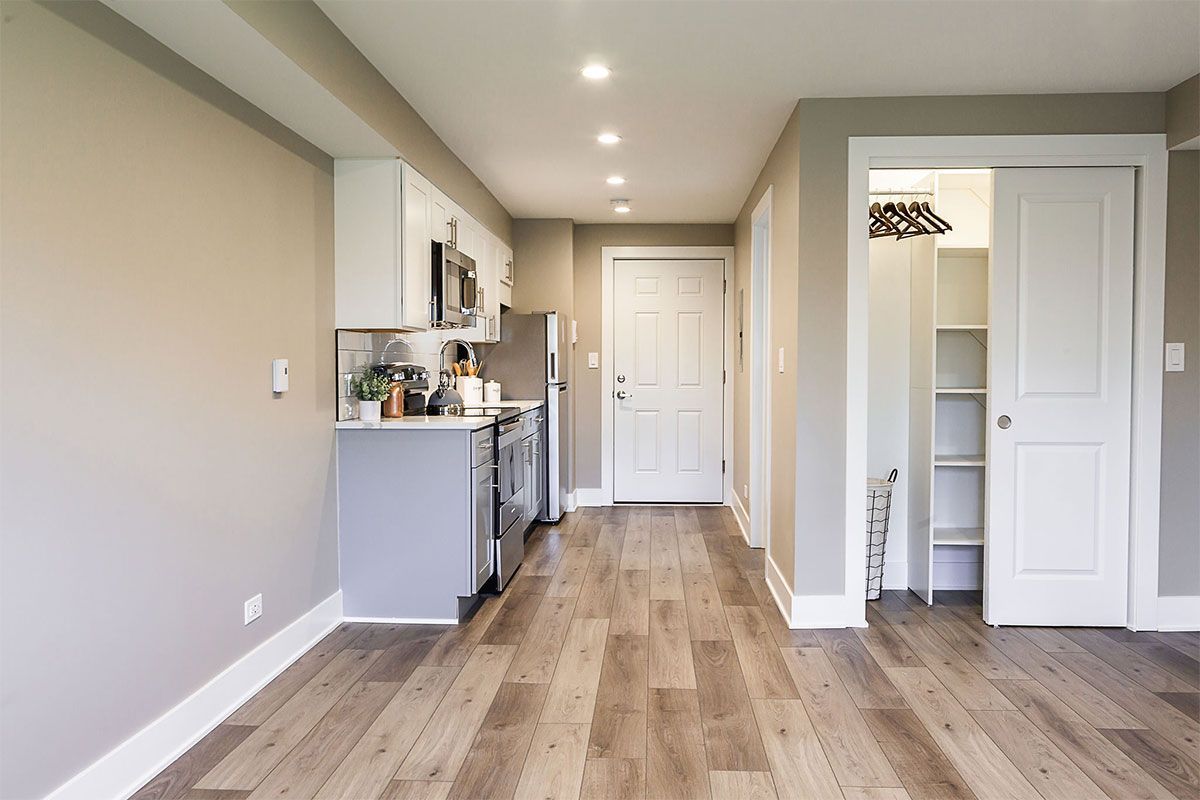 there is a kitchen in the middle of the room .