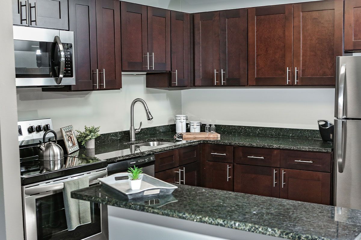 a kitchen with stainless steel appliances and wooden cabinets