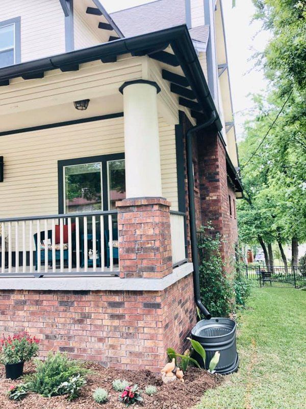a house with a brick porch and a white railing