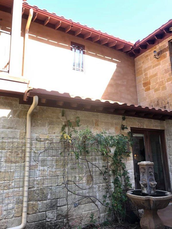 a brick building with a fountain in front of it