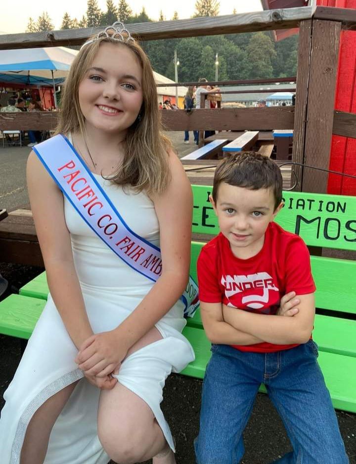 A girl is wearing a sash that says pacific co fair
