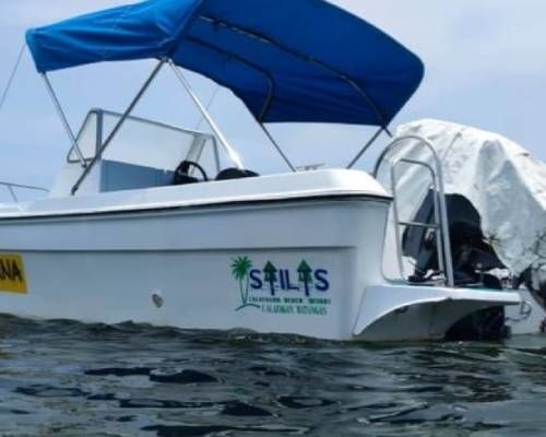 White motorboat with blue canopy on water, logo reads