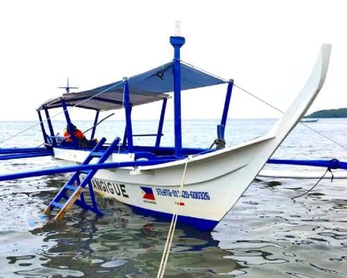 White and blue outrigger boat