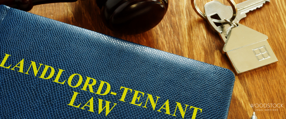 Landlord tenant law book with gavel and house keys on wooden desk, symbolising property possession
