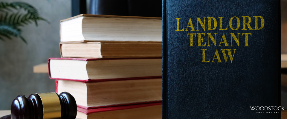 Stack of law books and a judge’s gavel beside a landlord and tenant law textbook.