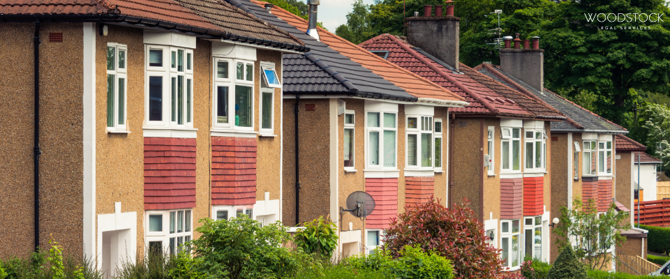 Traditional red brick UK terraced homes with bay windows, Woodstock Legal Services