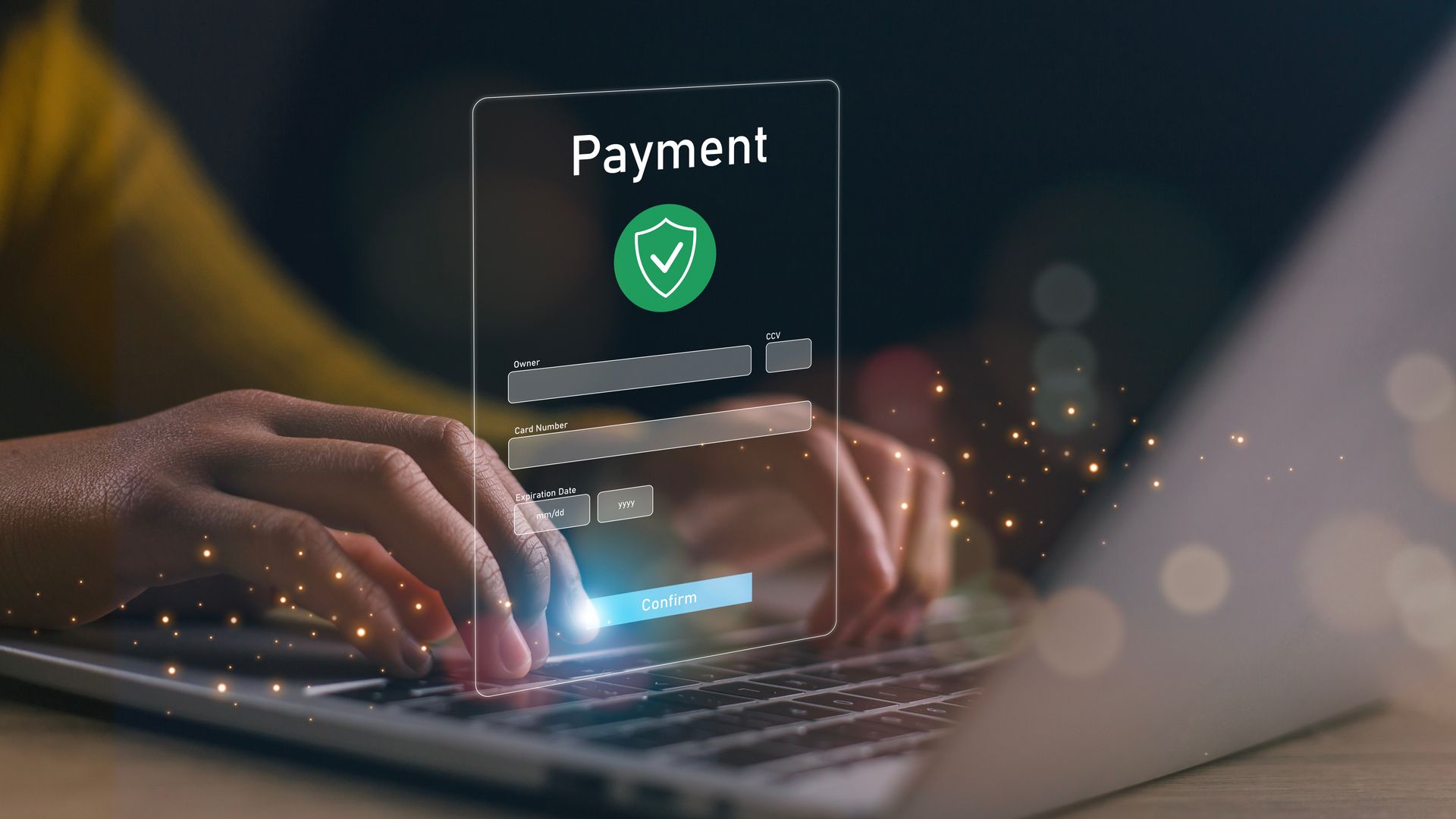 Hands typing on a laptop with a glowing payment approval icon on screen