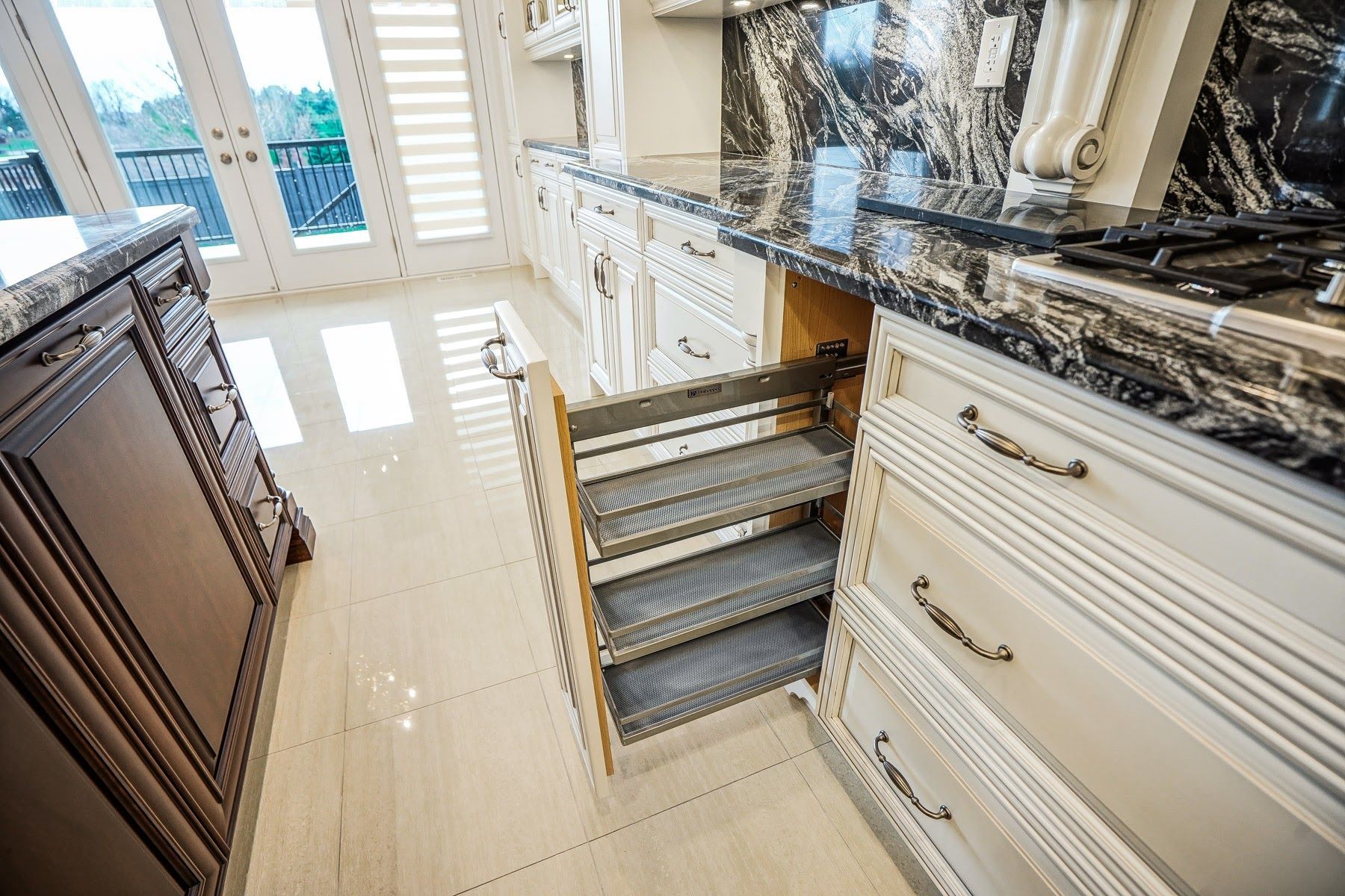 A kitchen with a lot of drawers and a stove top oven.