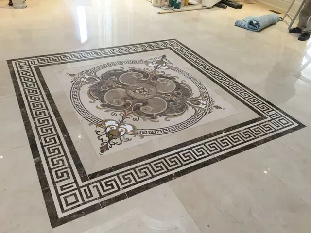 Square marble floor inlay with decorative border and central design.