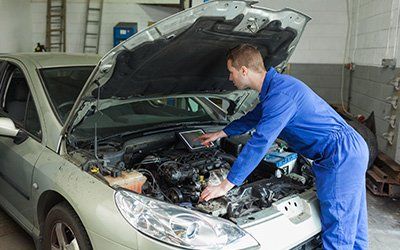 Mechanic Examining Car Engine — Auto Repair In Opelika, AL