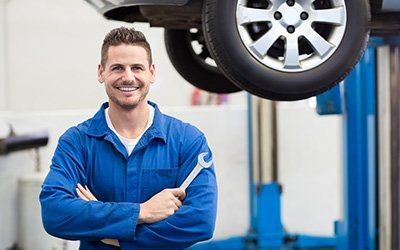 Mechanic Holding Tool — Car Maintenance In Opelika, AL