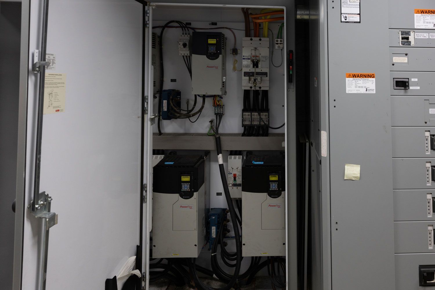 An open electrical box with a lot of wires coming out of it