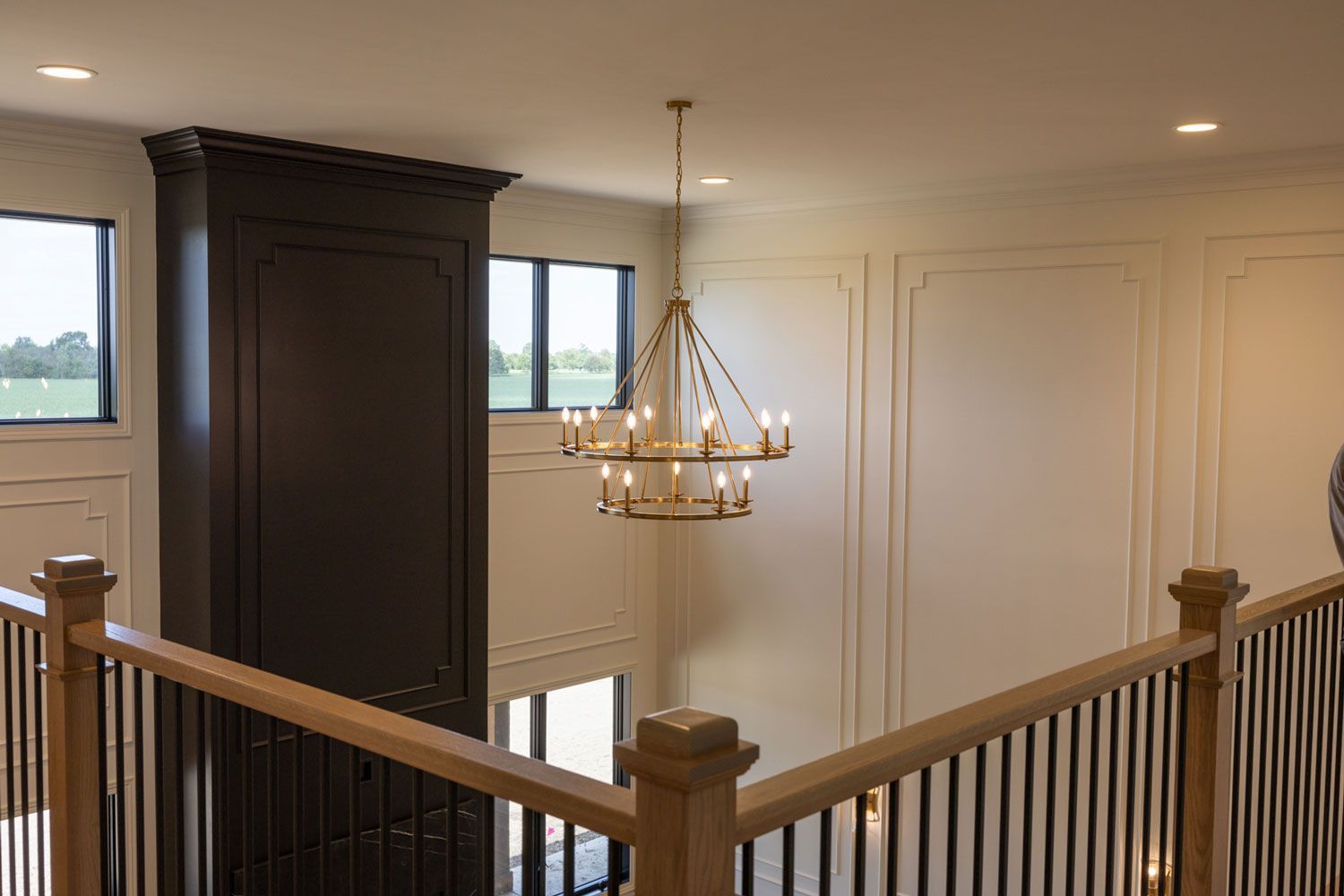 There is a chandelier hanging from the ceiling in the middle of the room.