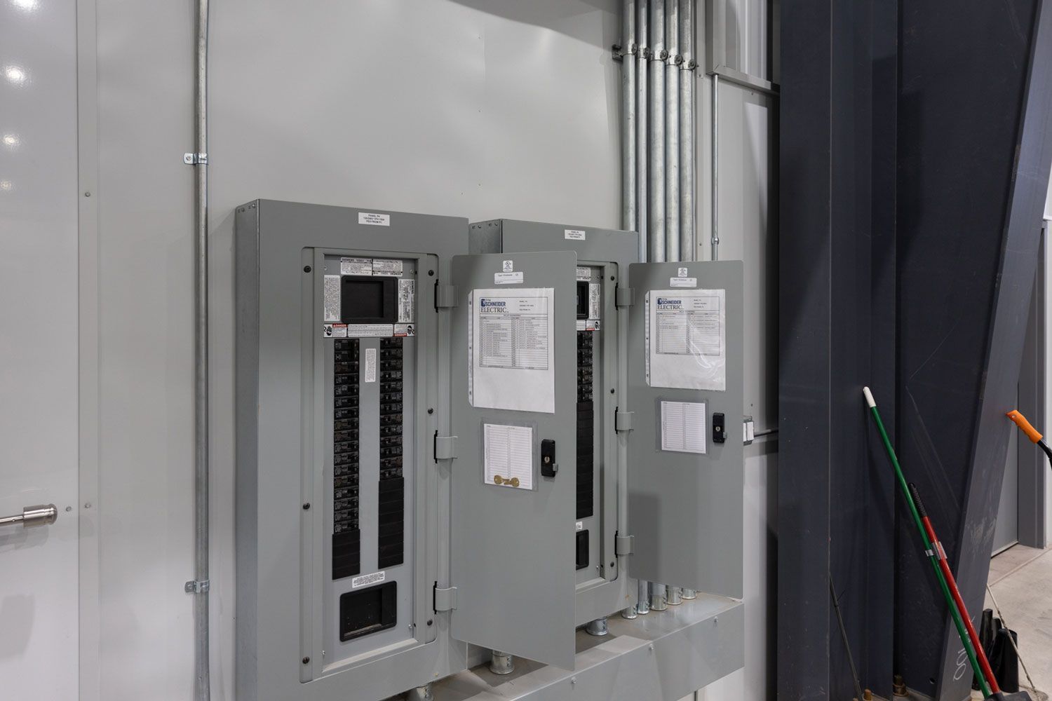 There are a lot of electrical boxes on the wall.