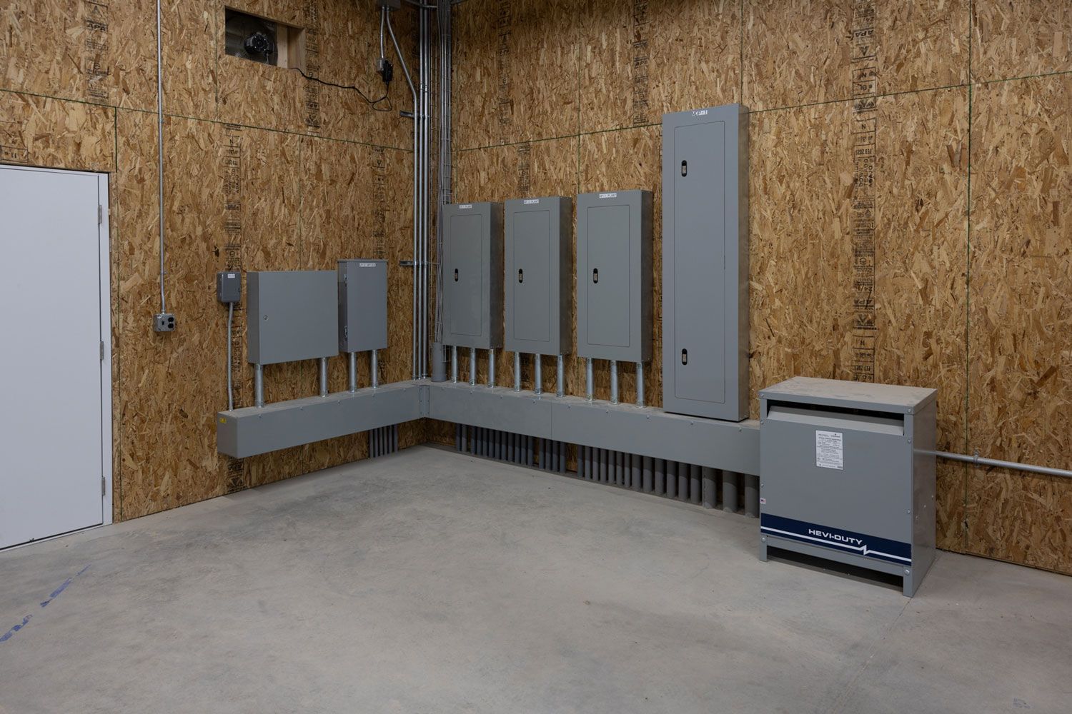 A room with a lot of electrical boxes on the wall