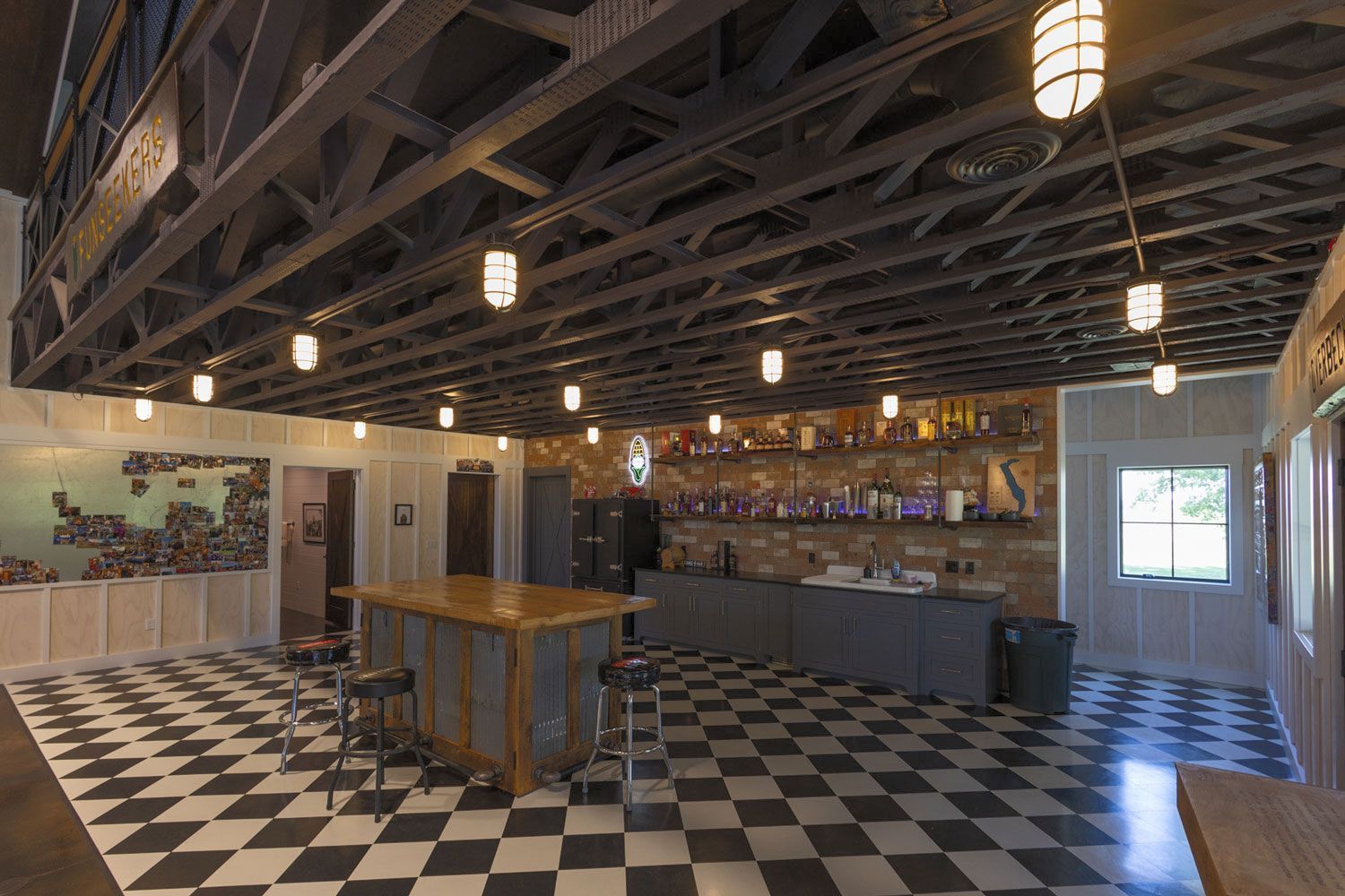 A large room with a checkered floor and a bar