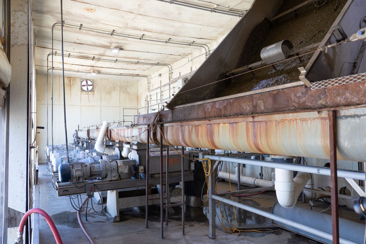 A large room with a lot of pipes and machinery in it.