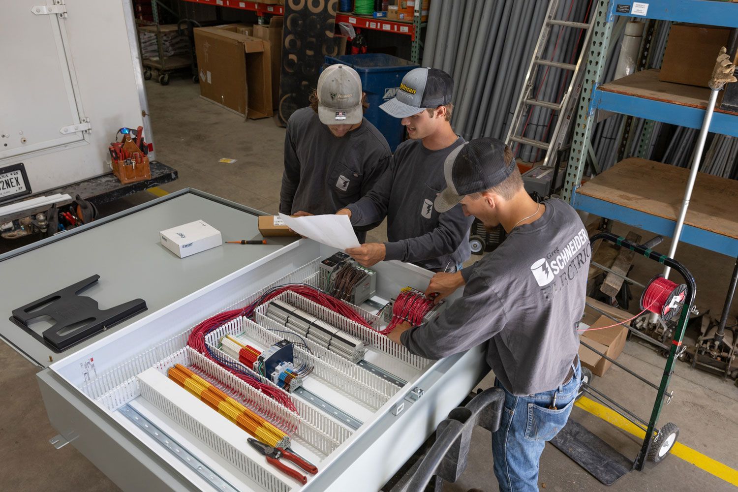 A group of men are working on a machine in a factory.