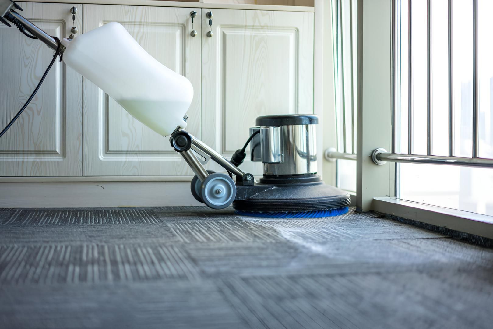 Vacuum Cleaner is Cleaning a Carpet in a Kitchen — Mr Steam Clean Tweed Coast in Murwillumbah, NSW