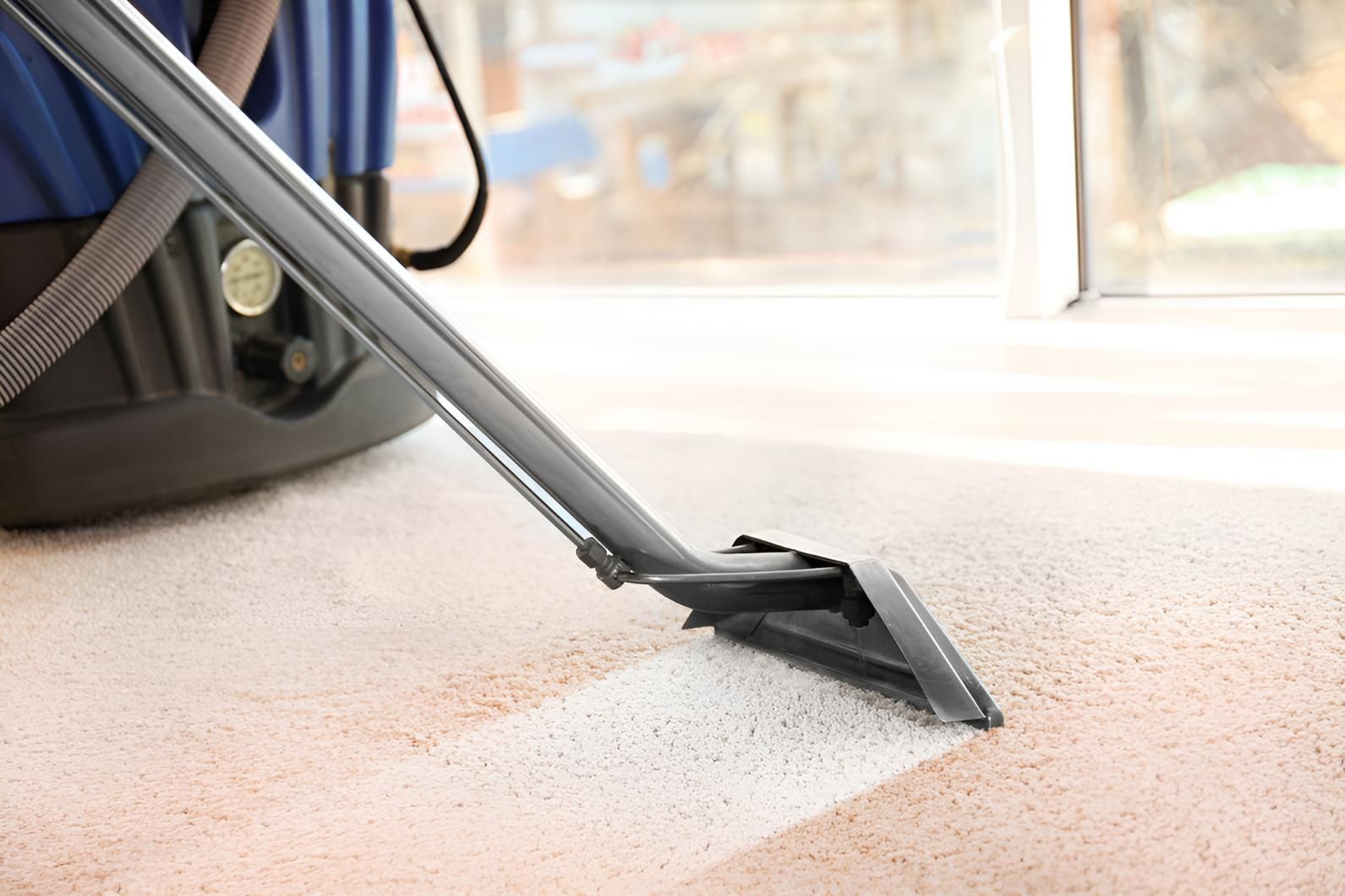 Vacuum Cleaner is Cleaning a Carpet in a Room — Mr Steam Clean Tweed Coast in Elanora, QLD